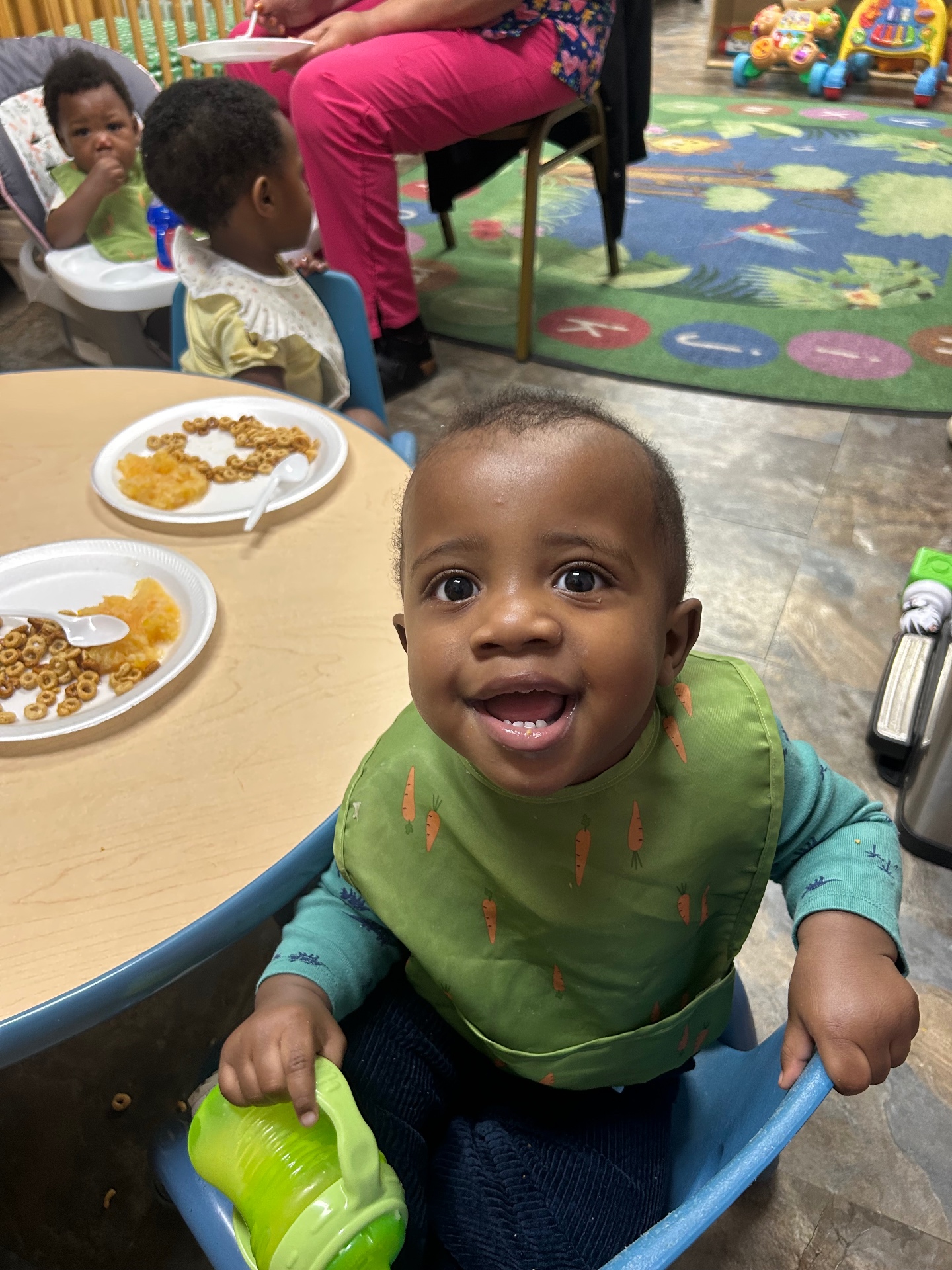 A happy infant at mealtime in our nursery