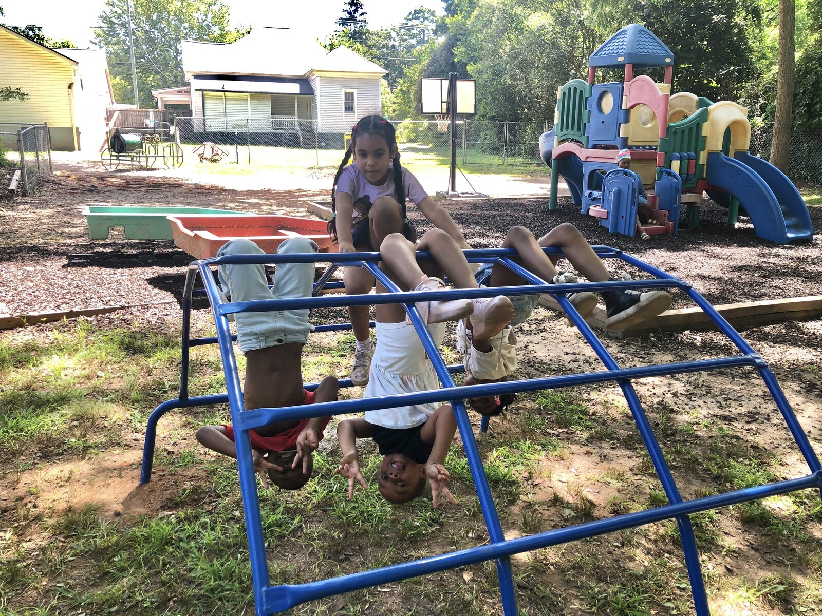 Children playing on the monkey bars at the playground